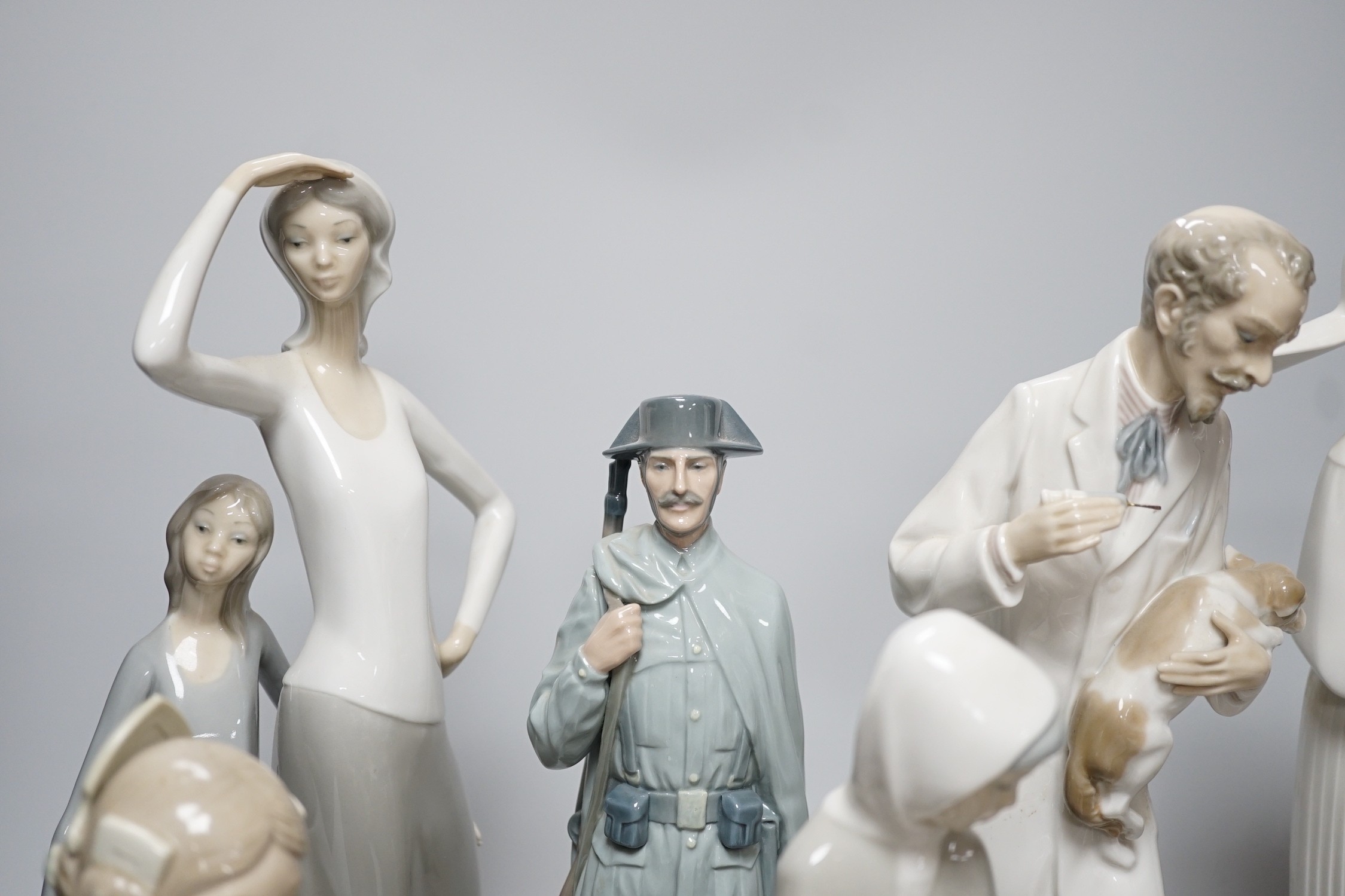 A collection of nine Lladro porcelain figures, tallest 36cm